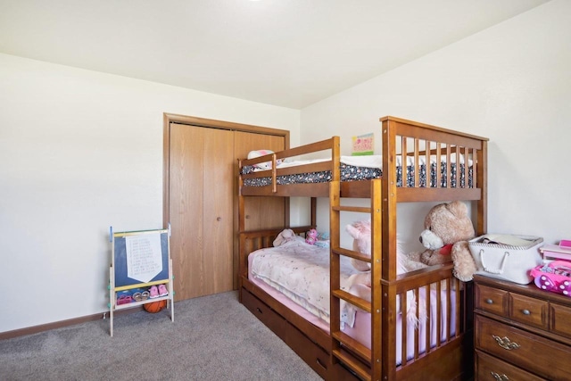 bedroom featuring a closet, carpet flooring, and baseboards