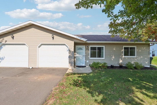 ranch-style house with a garage, a front lawn, and aphalt driveway