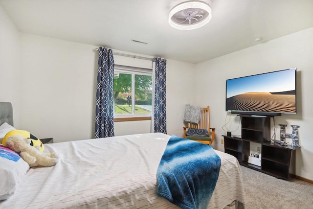 bedroom featuring baseboards, visible vents, and carpet flooring