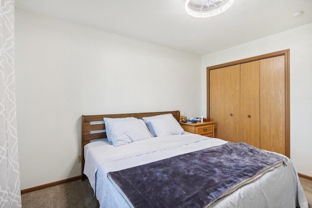 carpeted bedroom with baseboards and a closet