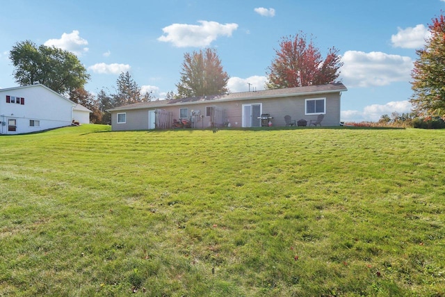 rear view of property with a yard