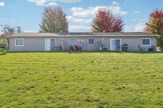 rear view of property with a yard