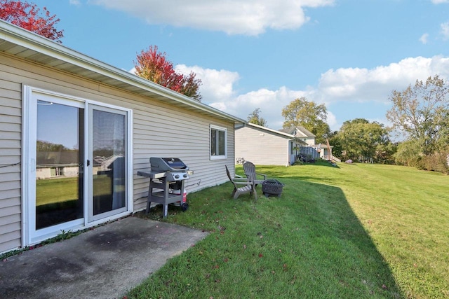 view of yard with an outdoor fire pit and a patio