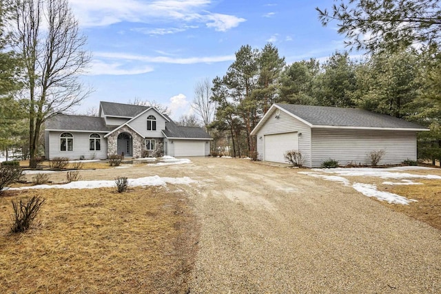 view of front of house with a detached garage and an outdoor structure