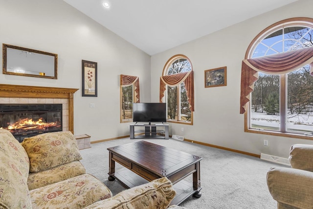 carpeted living room featuring visible vents, baseboards, a tile fireplace, vaulted ceiling, and recessed lighting