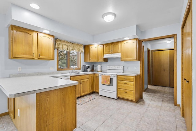 kitchen featuring light countertops, electric range, a sink, a peninsula, and under cabinet range hood