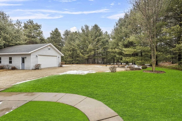 view of yard featuring an outbuilding and a garage