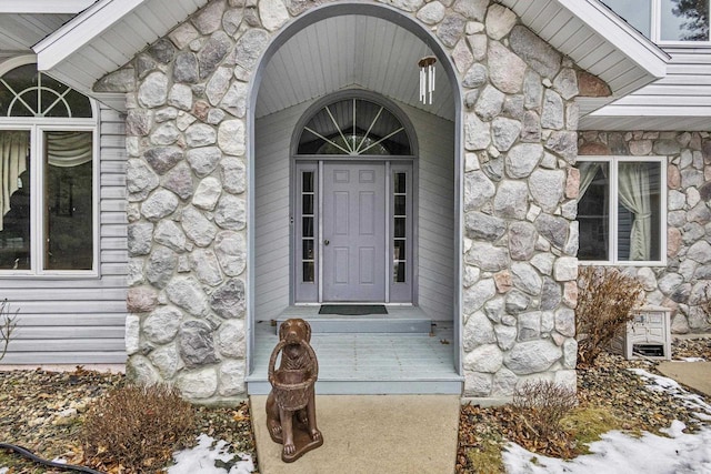 view of exterior entry featuring stone siding