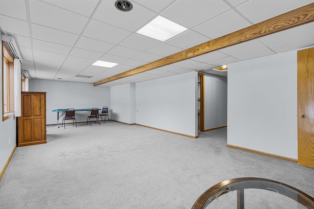 interior space featuring carpet flooring, a paneled ceiling, and baseboards