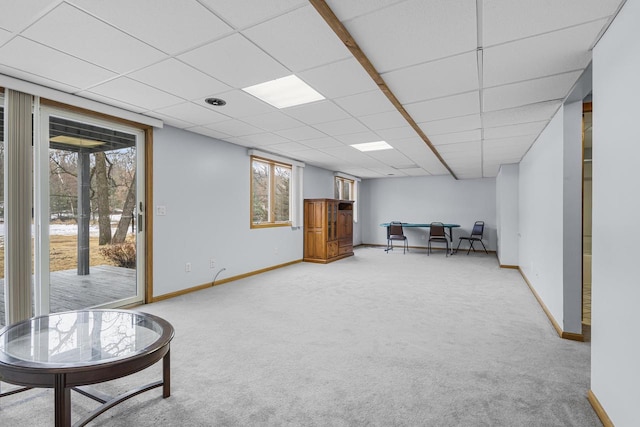 living area with a wealth of natural light, carpet, and baseboards