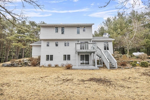 back of house with stairs and a deck