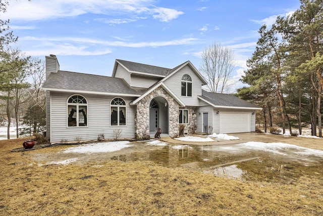 traditional home with a garage, stone siding, a shingled roof, and a chimney