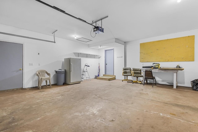 garage with freestanding refrigerator and a garage door opener