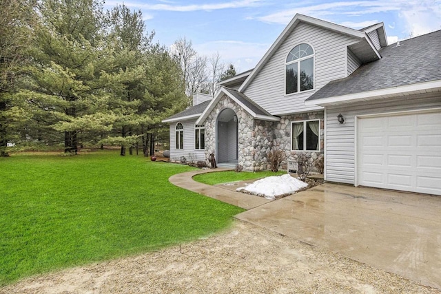 view of front facade featuring a chimney, an attached garage, a front yard, stone siding, and driveway