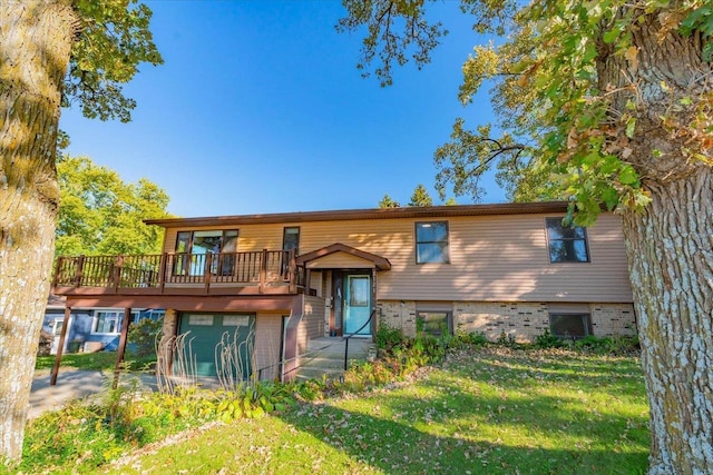 back of house featuring a garage, a lawn, and brick siding