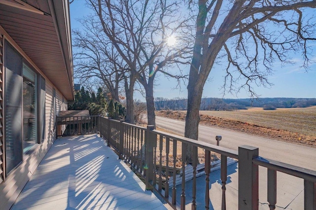 wooden terrace featuring a rural view