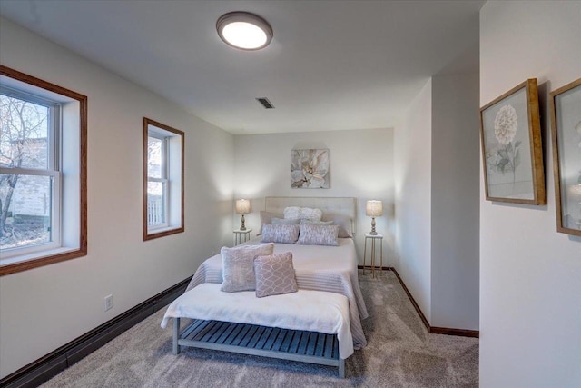 bedroom featuring visible vents, baseboards, and carpet floors