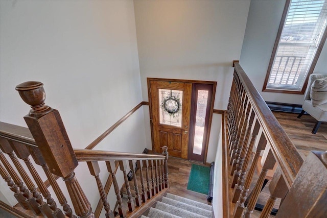 foyer entrance featuring stairs and wood finished floors