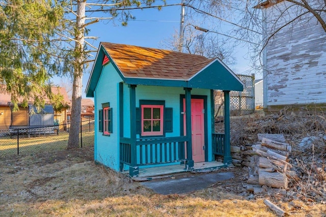 view of outbuilding featuring an outbuilding and fence