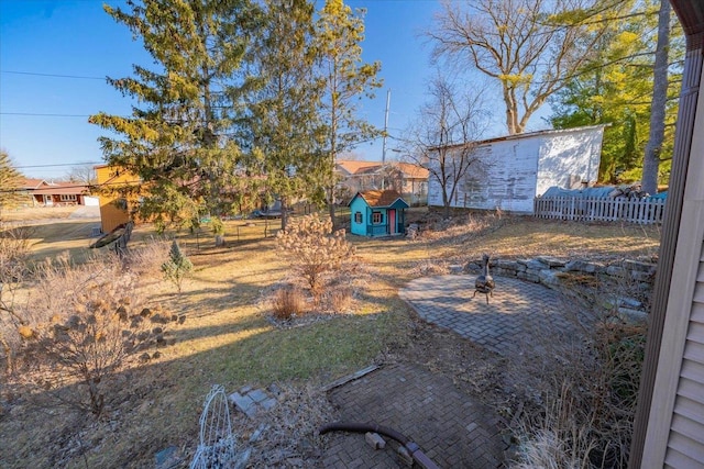 view of yard with an outdoor structure and fence