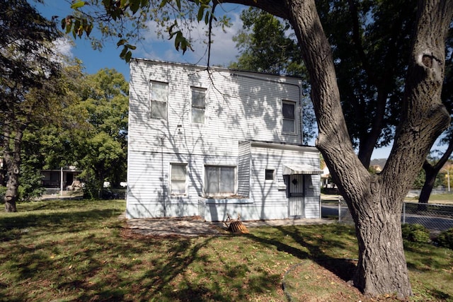 view of home's exterior with a yard and fence