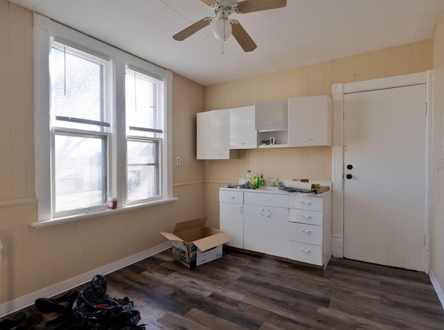 kitchen with dark wood-type flooring, white cabinets, baseboards, and open shelves