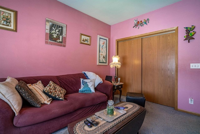 living room featuring carpet floors and baseboards