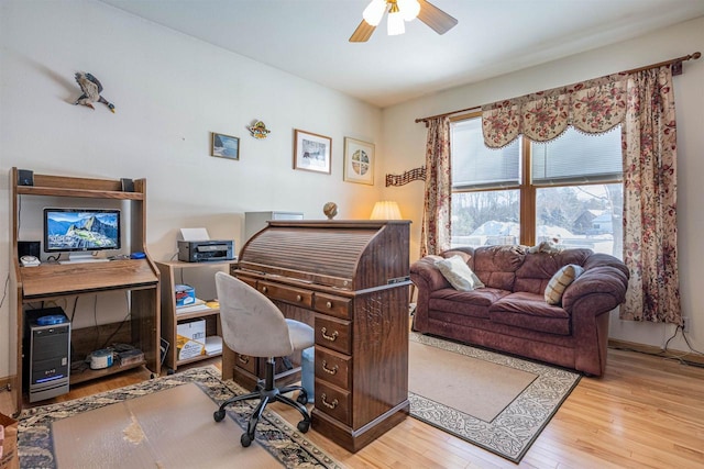 office area with a ceiling fan and wood finished floors