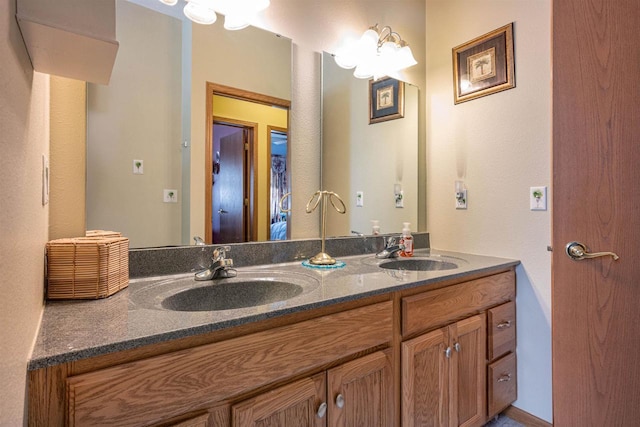 full bathroom with double vanity and a sink