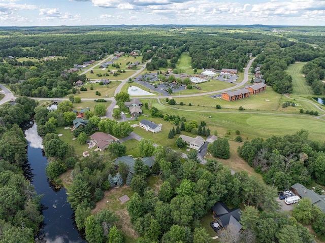 aerial view with a water view and a forest view