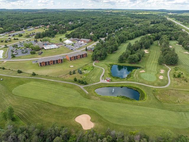 drone / aerial view with a water view and golf course view