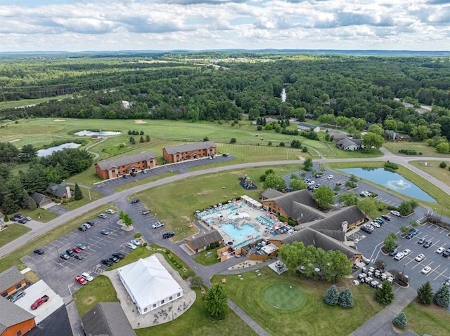 birds eye view of property with a water view and a view of trees