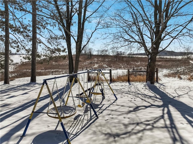 snow covered patio with a playground