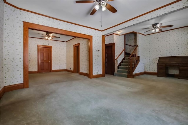 unfurnished living room featuring wallpapered walls, baseboards, stairway, ornamental molding, and carpet floors