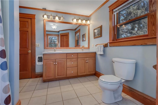 bathroom featuring crown molding, double vanity, toilet, a sink, and tile patterned floors