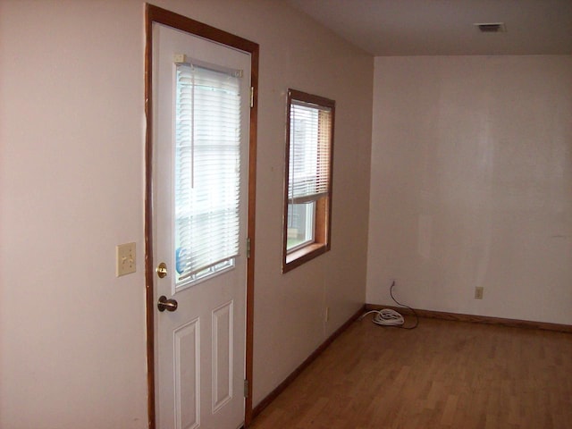 800 Thompson St, Portage, WI 53901 - doorway to outside featuring light wood-type flooring and baseboards