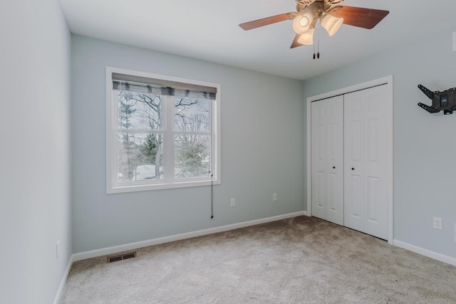 unfurnished bedroom with a closet, baseboards, visible vents, and carpet flooring