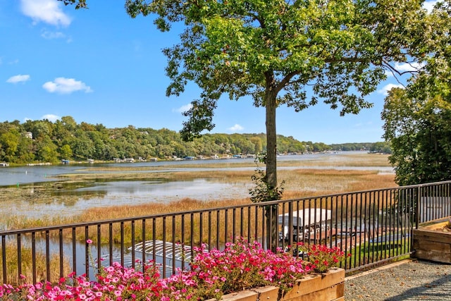 exterior space with a water view and fence