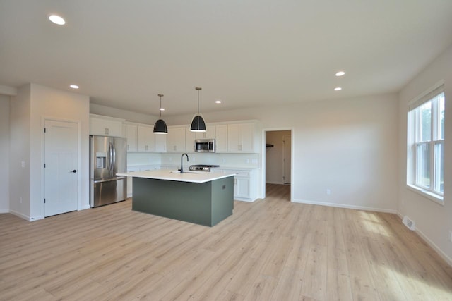 W198N5372 Boxwood Blvd, Menomonee Falls, WI 53051 - kitchen with stainless steel appliances, a sink, recessed lighting, light countertops, and baseboards