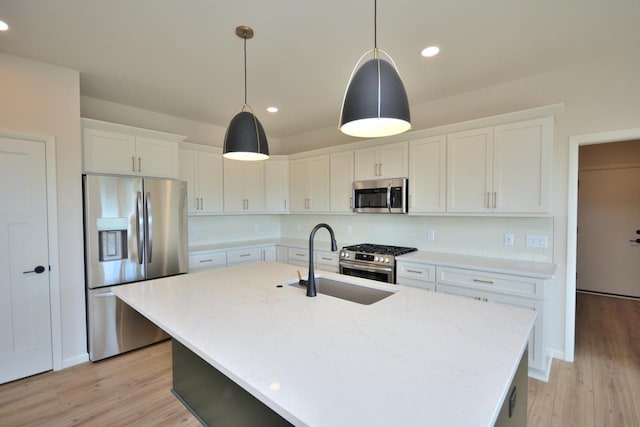 W198N5372 Boxwood Blvd, Menomonee Falls, WI 53051 - kitchen with stainless steel appliances, a sink, white cabinets, light wood finished floors, and recessed lighting