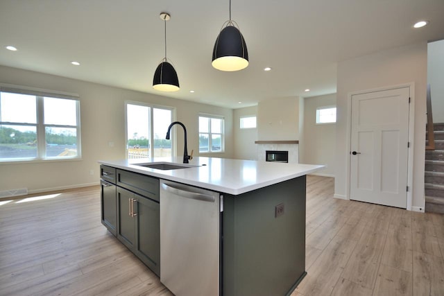 W198N5372 Boxwood Blvd, Menomonee Falls, WI 53051 - kitchen with stainless steel dishwasher, a sink, light countertops, light wood-style flooring, and recessed lighting