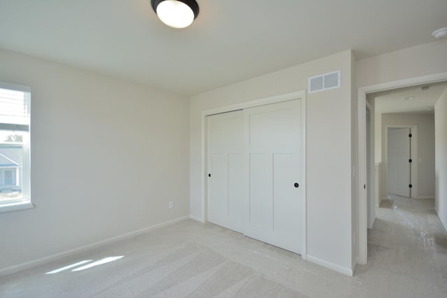 W198N5372 Boxwood Blvd, Menomonee Falls, WI 53051 - unfurnished bedroom featuring a closet, light colored carpet, and baseboards