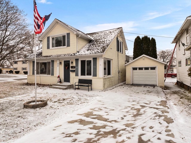 view of front of home featuring driveway, a detached garage, and an outdoor structure