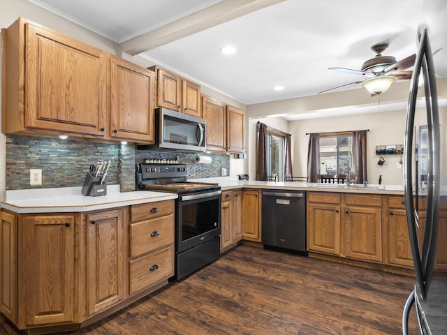 kitchen featuring stainless steel appliances, tasteful backsplash, dark wood-type flooring, ornamental molding, and a sink