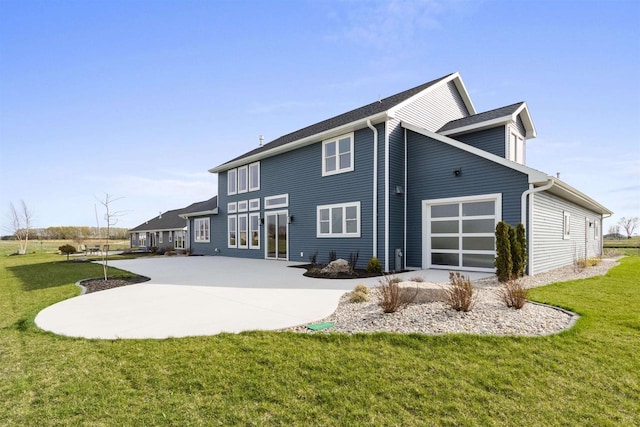 back of house with a garage, a patio, a lawn, and driveway