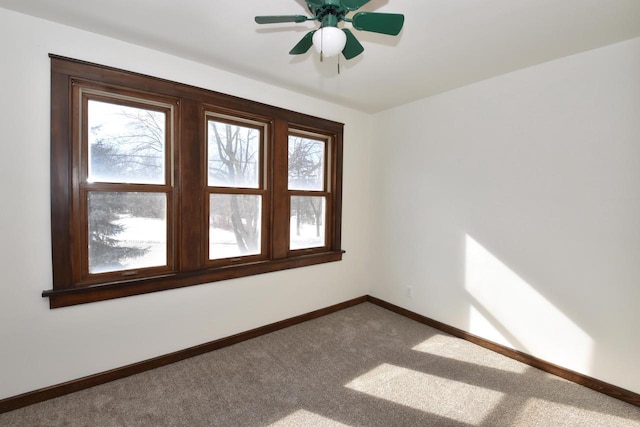 spare room featuring carpet floors and baseboards