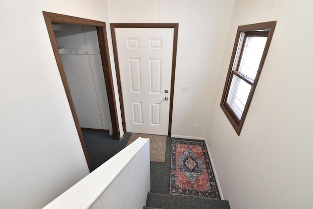 interior space with carpet and baseboards