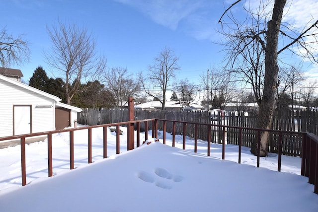 yard covered in snow with a fenced backyard