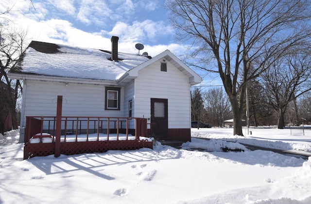 snow covered property featuring a deck