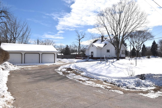 exterior space with a garage and an outbuilding